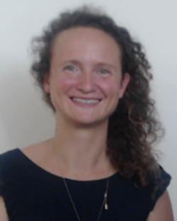 A headshot of isabelle with long culy hair and a black top